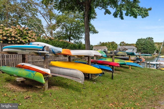 view of jungle gym featuring a water view and a lawn