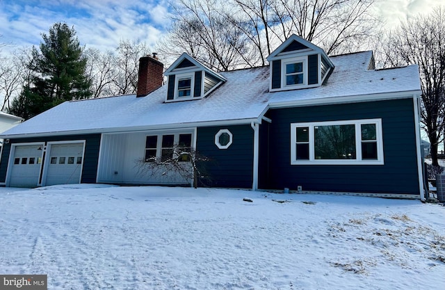 new england style home featuring a garage