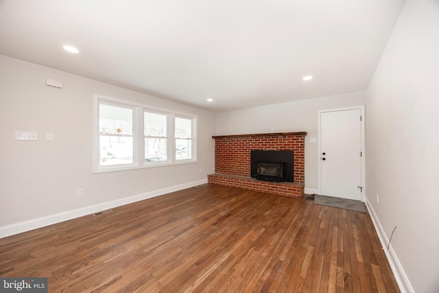 unfurnished living room featuring dark hardwood / wood-style floors