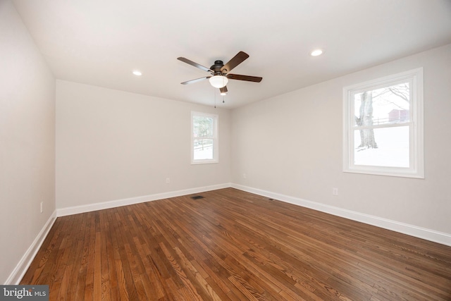 empty room with dark hardwood / wood-style floors and ceiling fan