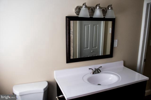 bathroom with toilet and vanity