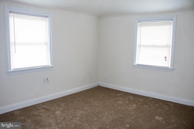 carpeted spare room with a healthy amount of sunlight