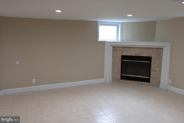 unfurnished living room with a high end fireplace