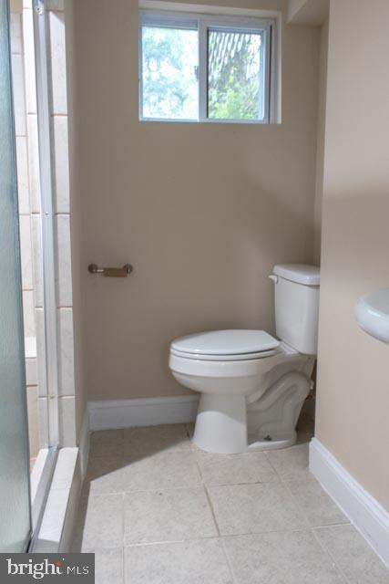 bathroom featuring tile patterned floors and toilet