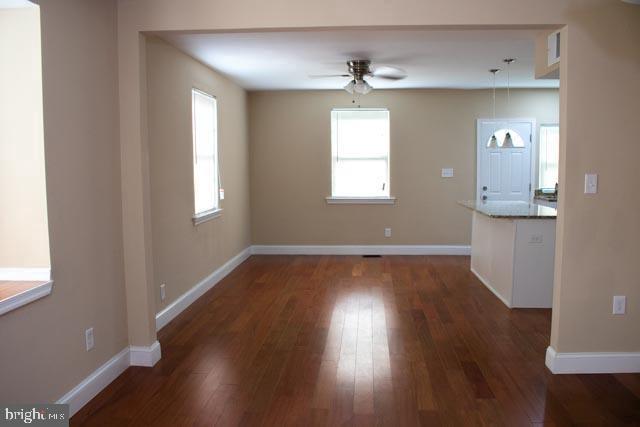 interior space featuring ceiling fan and dark hardwood / wood-style flooring