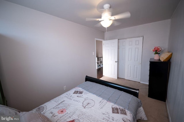 bedroom featuring ceiling fan, a closet, and carpet