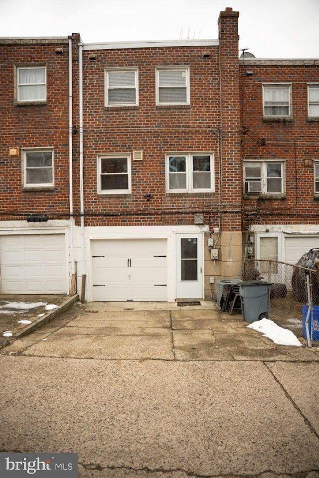 rear view of property with a garage