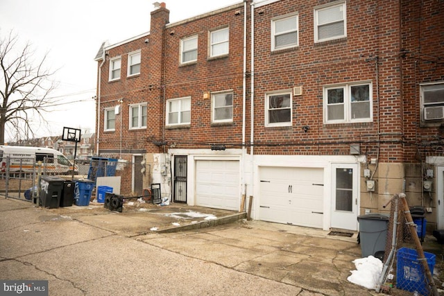 back of property featuring cooling unit and a garage