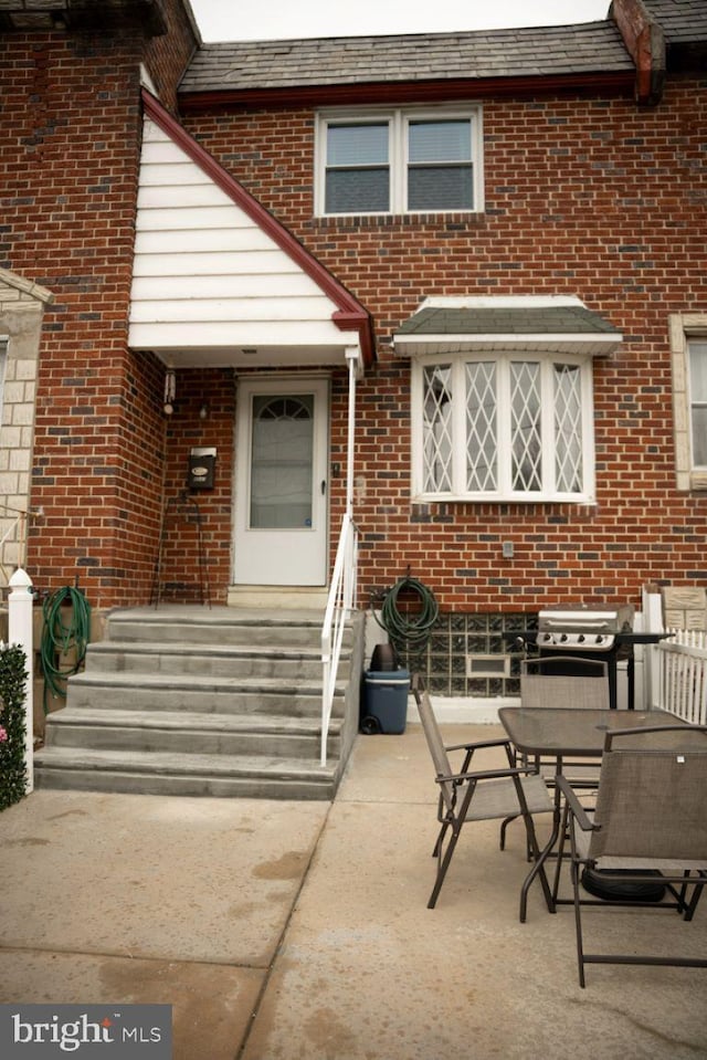 doorway to property with a patio area