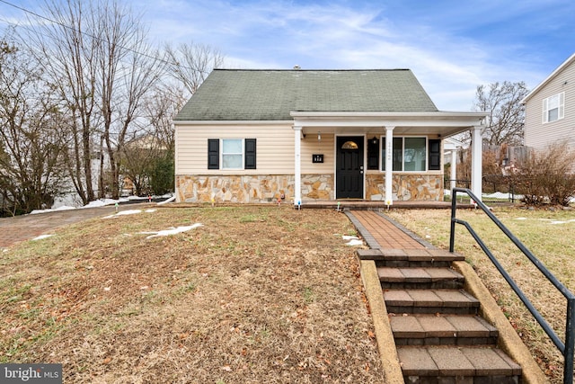 bungalow-style house with covered porch and a front yard