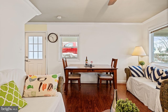 dining space with ceiling fan, dark wood-type flooring, and ornamental molding