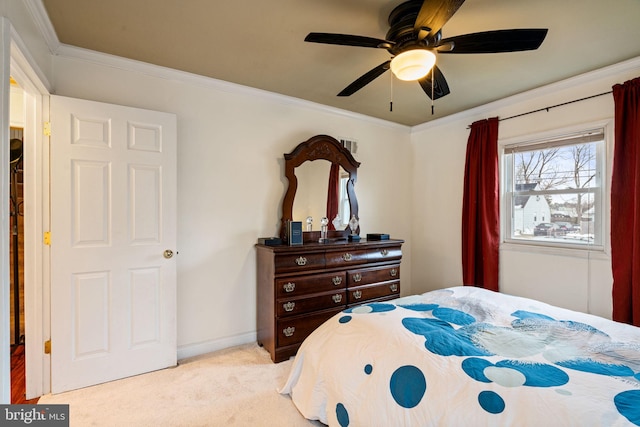 bedroom featuring ceiling fan, light colored carpet, and ornamental molding