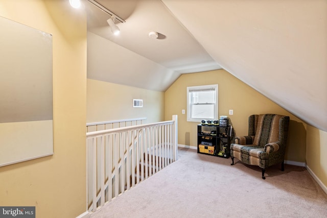 living area with light carpet and vaulted ceiling