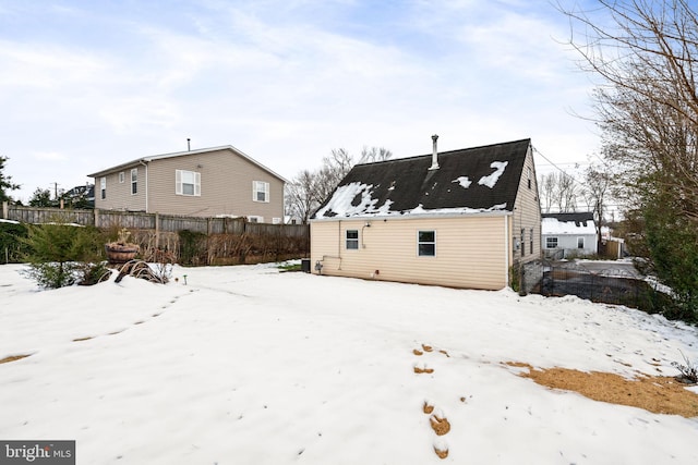 view of snow covered rear of property