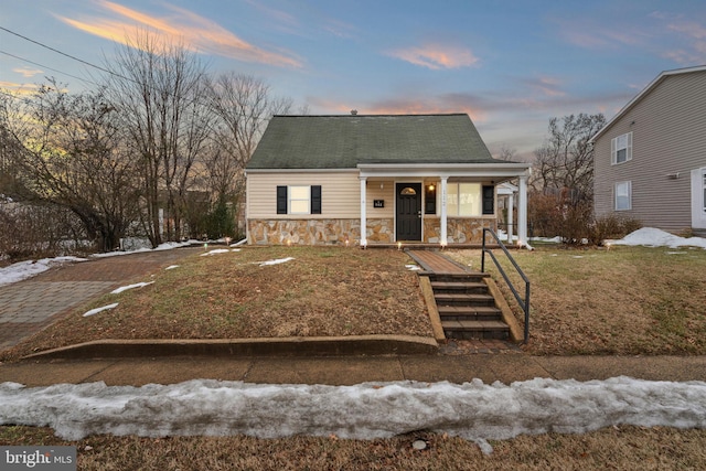 view of front of property with a yard and a porch