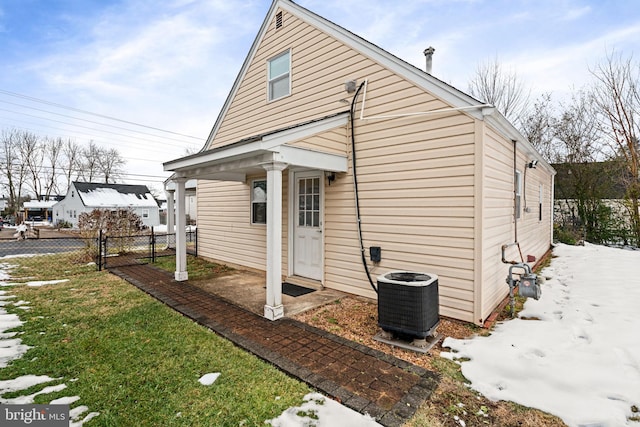 view of home's exterior featuring central AC unit and a lawn