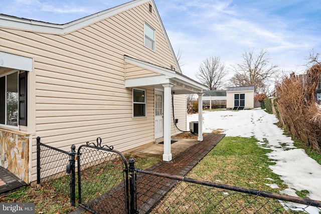 view of property exterior featuring central AC unit and a shed