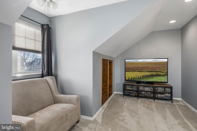 sitting room featuring vaulted ceiling and light carpet