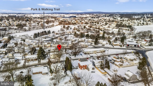 snowy aerial view featuring a mountain view