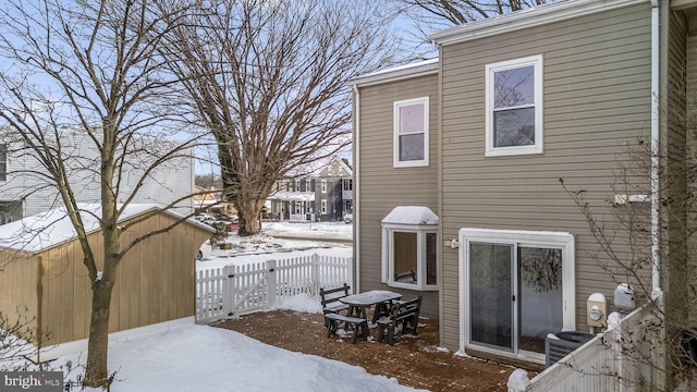 view of snow covered exterior with central AC