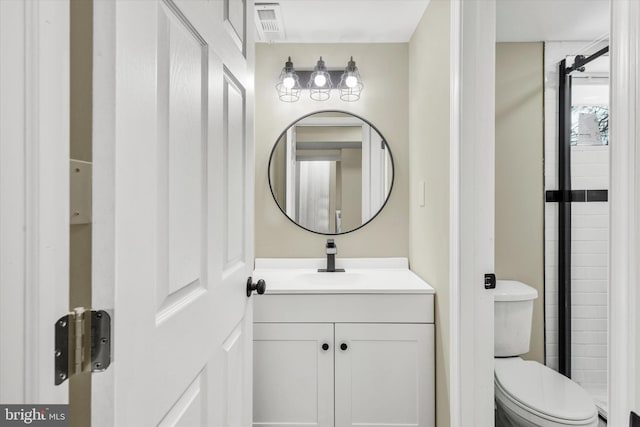 bathroom featuring toilet and vanity