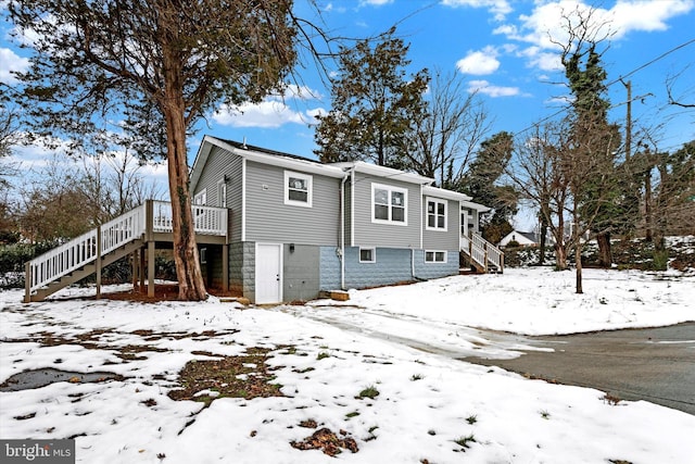 view of snow covered back of property