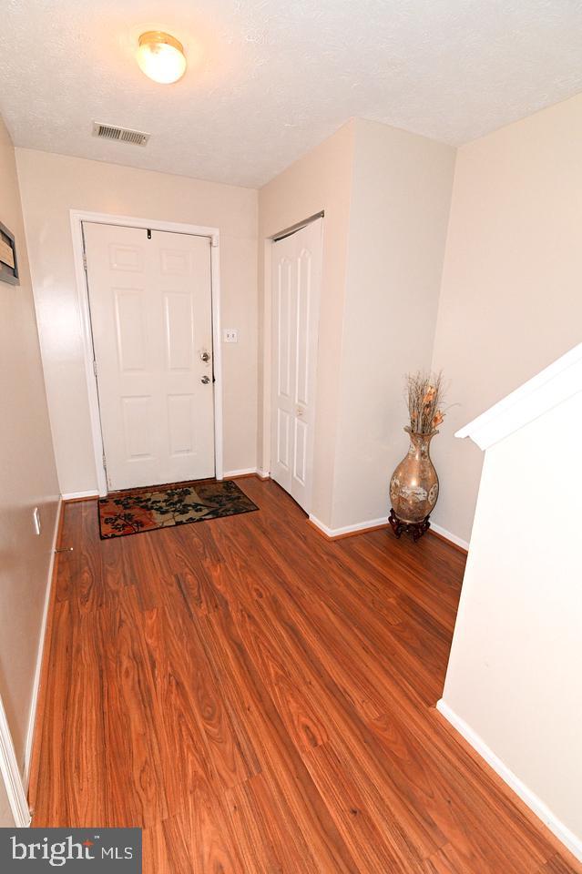 entryway with hardwood / wood-style floors