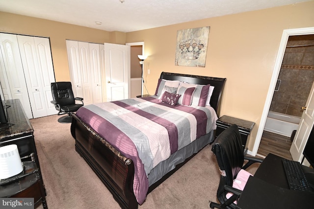 bedroom with carpet flooring and two closets