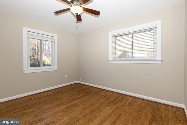 empty room featuring ceiling fan, hardwood / wood-style floors, and a wealth of natural light