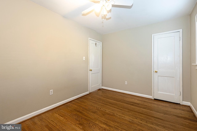 spare room featuring dark hardwood / wood-style floors and ceiling fan