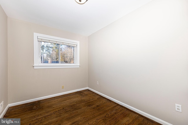 empty room with dark hardwood / wood-style flooring