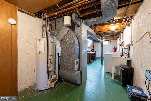 basement featuring water heater, heating unit, and washing machine and clothes dryer