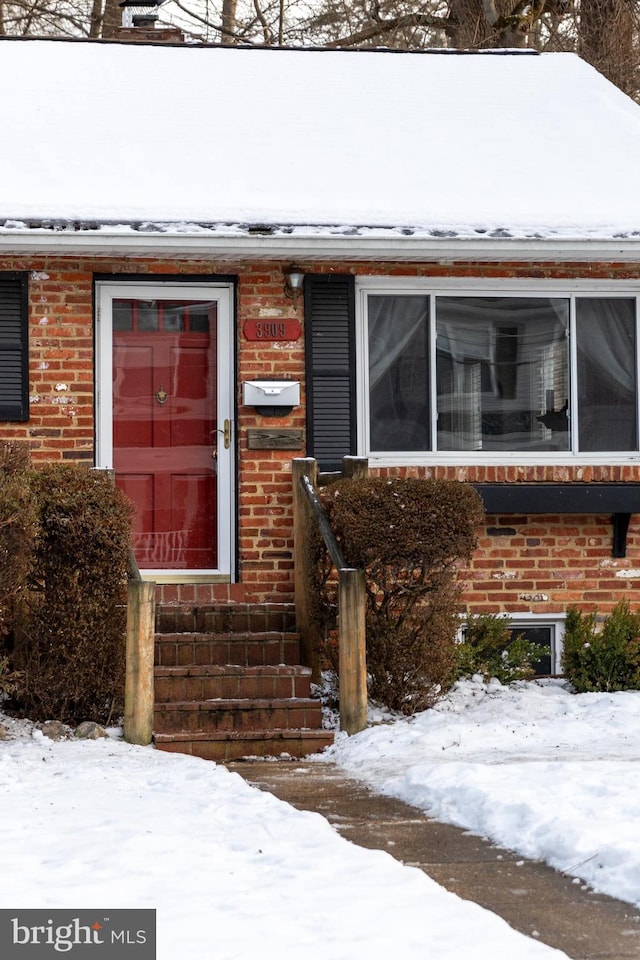 view of snow covered property entrance