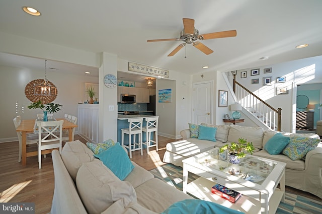 living room with ceiling fan and wood-type flooring