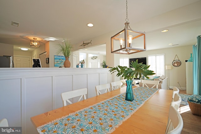 dining room with hardwood / wood-style flooring and a chandelier