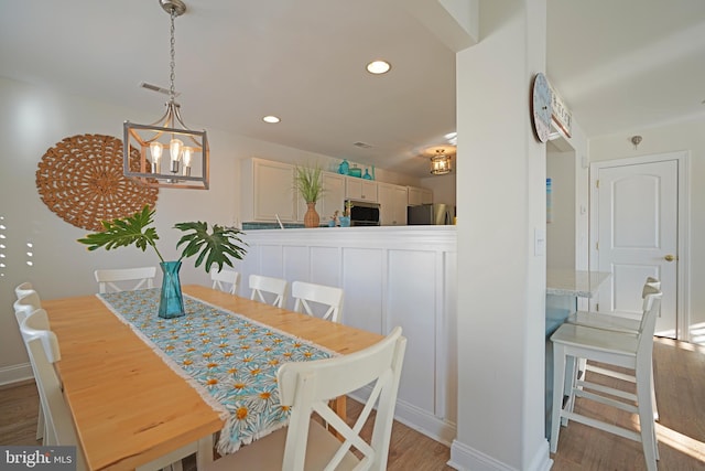 dining room with a chandelier and hardwood / wood-style floors