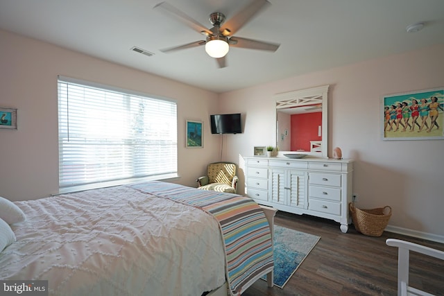 bedroom with ceiling fan and dark hardwood / wood-style flooring