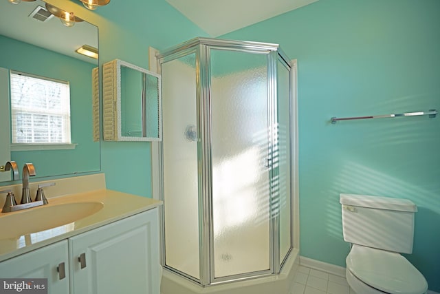 bathroom featuring vanity, toilet, walk in shower, and tile patterned floors