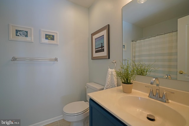 bathroom featuring tile patterned floors, toilet, and vanity