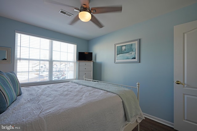 bedroom with ceiling fan and dark hardwood / wood-style flooring