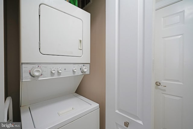 laundry room with stacked washer and dryer