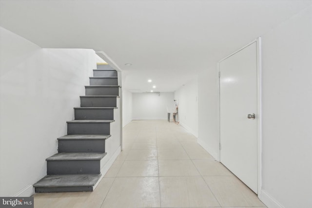 hall featuring light tile patterned floors