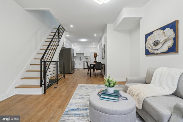 living room with sink and light wood-type flooring