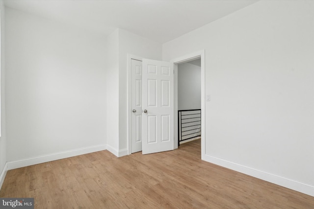 unfurnished room with light wood-type flooring