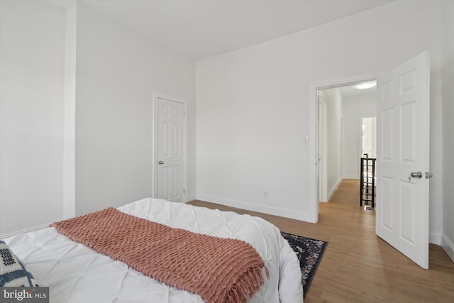 bedroom with hardwood / wood-style flooring