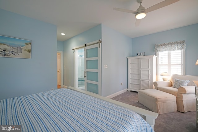 carpeted bedroom featuring ceiling fan and a barn door