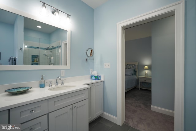 bathroom featuring vanity, a shower with shower door, and tile patterned floors