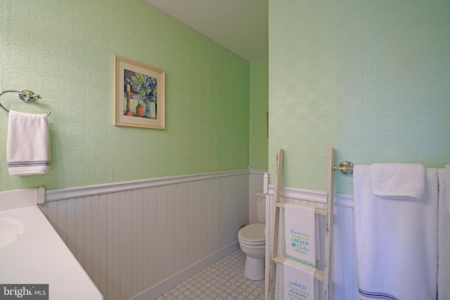 bathroom with tile patterned flooring, vanity, and toilet