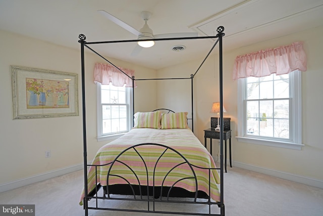 carpeted bedroom featuring multiple windows and ceiling fan