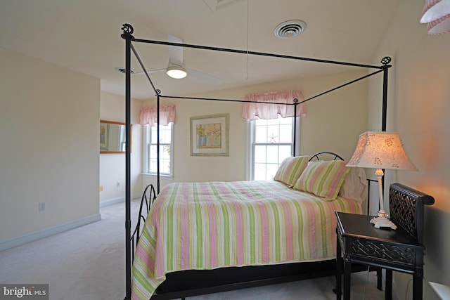 carpeted bedroom with vaulted ceiling and ceiling fan